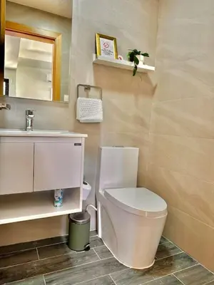 a bathroom with a white toilet and a sink at Stunning City Center Condo in Los Prados