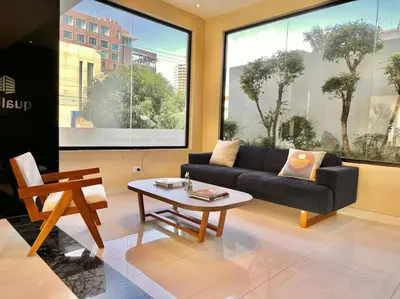 a living room with a couch and a coffee table at Stunning City Center Condo in Los Prados