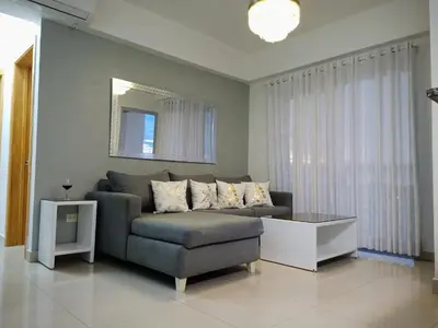 a living room with a couch and a mirror at Elegant and confortable close to Boca Chica Beach in Boca Chica
