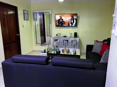a living room with a couch and a table at Entire apartment Tu Nido De Amor 2 Santo Domingo West in Santo Domingo