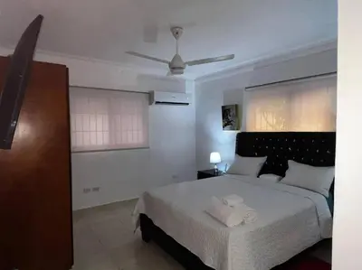 a bedroom with a bed with two towels on it at Entire apartment Tu Nido De Amor 2 Santo Domingo West in Santo Domingo