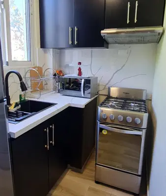 a kitchen with a stove and a microwave at Apartaestudio en el centro de Puerto Plata in San Felipe de Puerto Plata