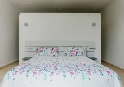 a bedroom with a large white bed with flowers on it at Private Villa 4 BR at Playa Bonita, Las Terrenas in Las Terrenas