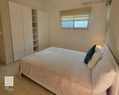 a bedroom with a bed with a blue pillow at 2JA Management Group - Condos White Hill in Sosúa