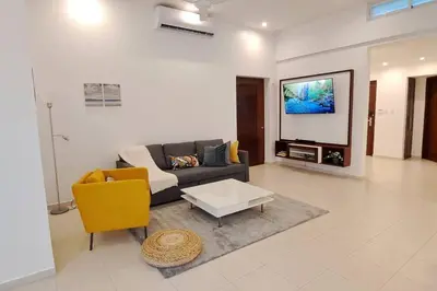 a living room with a couch and a tv at Deluxe villa with jacuzzi and beautiful garden in Santiago de los Caballeros