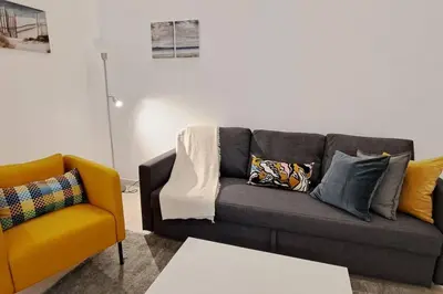 a living room with a couch and a chair at Deluxe villa with jacuzzi and beautiful garden in Santiago de los Caballeros