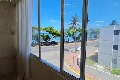 a window with a view of a street and the ocean at Apartament central frente al mar in San Felipe de Puerto Plata