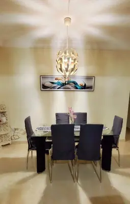 a dining room table with chairs and a chandelier at Pine Tree Entire House 2B Gated Com in Higuey