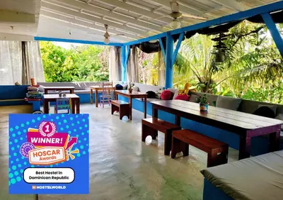 a restaurant with tables and chairs and a sign that reads winzeraza at Hostel 23 in Las Terrenas