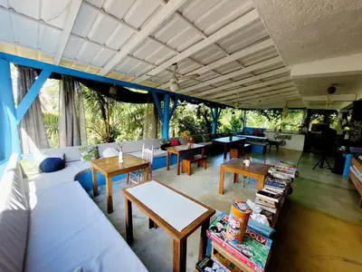 a living room with a couch and tables at Hostel 23 in Las Terrenas