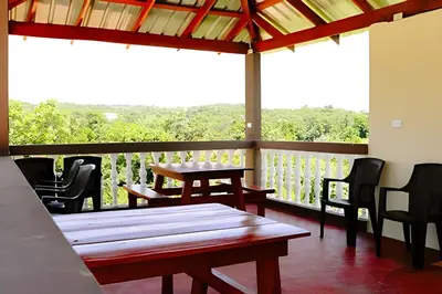 a patio with tables and chairs on a balcony at Apart hotel Costa Verde,#1 Exclusivo y seguro con cama Queen in Las Galeras