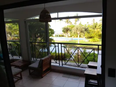a room with a window with a view of a yard at Bonita Village Beachfront Apt with Pool & Balcony in Las Terrenas