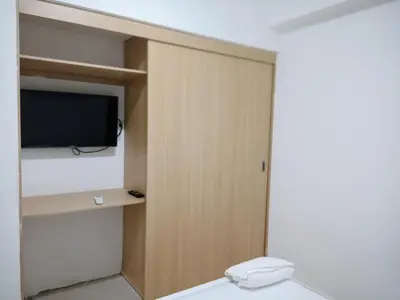 a bathroom with a toilet and a tv in a room at Confortable apto. en Boca Chica in Boca Chica