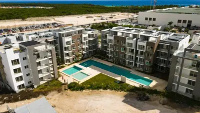 an aerial view of a building with a swimming pool at Hard Rock Punta Cana Luxe Apartment 2BR Coral Bay by BTC Crypto Group in Punta Cana