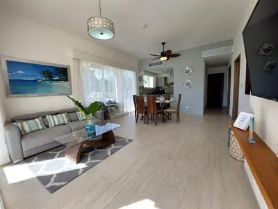 a living room with a couch and a table at Hard Rock Getaway • 2BR with Golf + Pool Views in Punta Cana