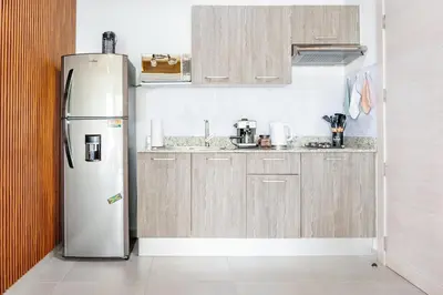 a kitchen with a stainless steel refrigerator and cabinets at Paradise Dream Dominicus in La Laguna