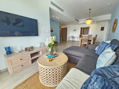 a living room with a couch and a table at 2BR Beach Condo • Prime Location Across Hard Rock in Punta Cana