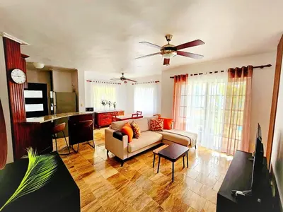 a living room with a couch and a ceiling fan at Madonna1 pool beach los corales Arenas de Bavaro in Punta Cana