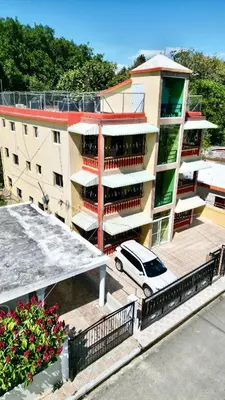 a car parked in front of a building at Oasis de Paz 4 in Jarabacoa