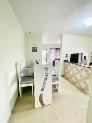 a kitchen and dining room with a table and chairs at Oasis de Paz 4 in Jarabacoa