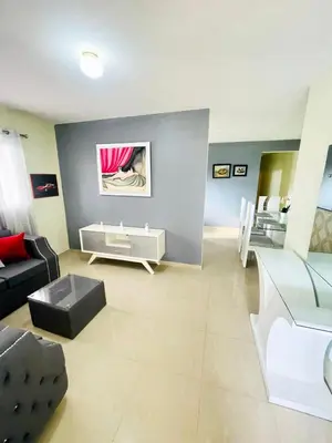 a living room with a couch and a table at Oasis de Paz 4 in Jarabacoa