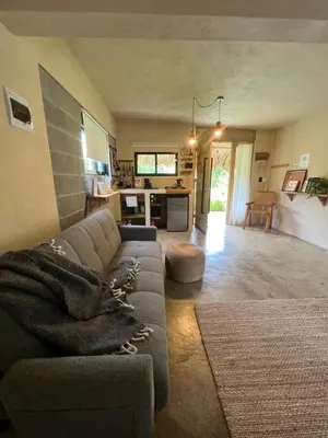 a living room with a couch with a blanket at CASAS LEON Casita de playa #2 in Santa Bárbara de Samaná