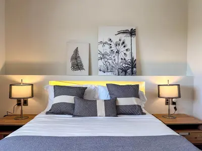 a bedroom with a large bed with two lamps at Fantastic Penthouse at Golf Course in Punta Cana