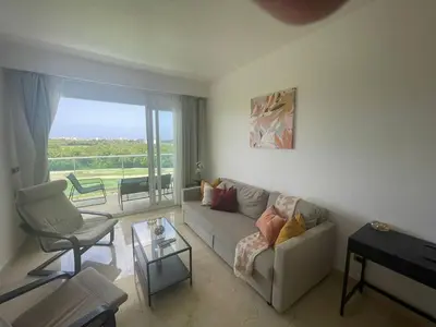 a living room with a couch and a chair at Hard Rock at Cana Rock 3 by Unwind Properties in Punta Cana