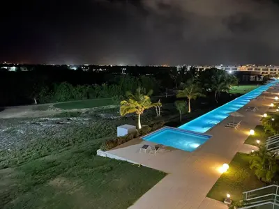 a swimming pool at night with a resort at Hard Rock at Cana Rock 3 by Unwind Properties in Punta Cana