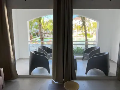 a view of a room with chairs and a mirror at Komfortowy Apartament z 4 Basenami i Pięknym Ogrodem, Estrella Dominicus-Bayahibe in Bayahibe