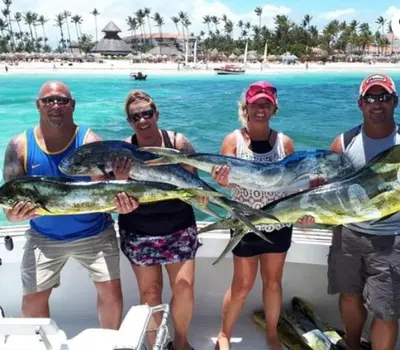 a group of people on a boat holding fish at Dios es Fiel - Ali Hotel in Punta Cana