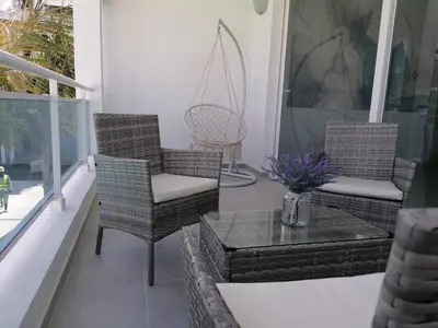 two wicker chairs and a table on a porch at Star of Caribbean- Estrella Dominicus Bayahibe in Bayahibe