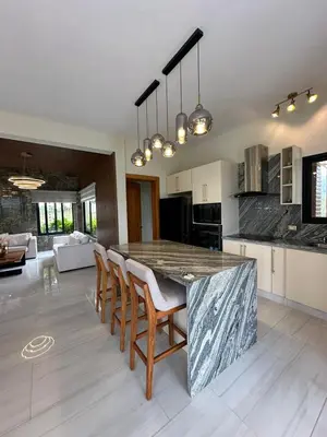 a kitchen with a large marble table and chairs at Luxury Mountain villa, Jarabacoa villa vargas in Concepción de La Vega