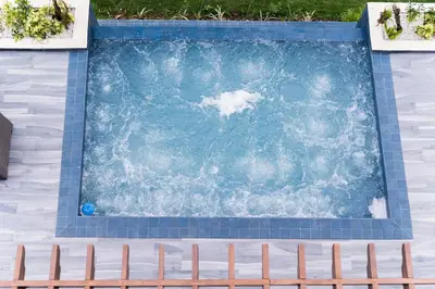 a swimming pool with a bench in front of it at Luxury Mountain villa, Jarabacoa villa vargas in Concepción de La Vega