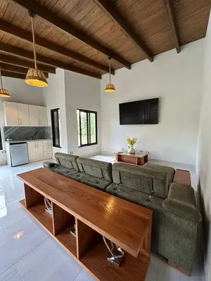 a living room with a couch and a table at Luxury Mountain villa, Jarabacoa villa vargas in Concepción de La Vega