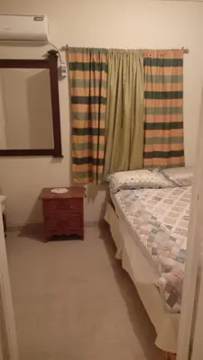 a bedroom with a bed and a mirror and a window at Classic House, Modern Spaces in Baní