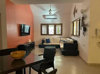 a living room with a couch and a table at Las Terrenas Villa- King Bed, Beaches & Dining in Las Terrenas
