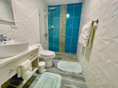 a bathroom with a sink and a toilet and a shower at Enjoy beach life at this gated in Juan Pedro