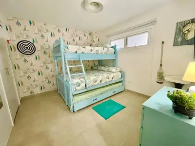 a bedroom with two bunk beds in a room at Enjoy beach life at this gated in Juan Pedro