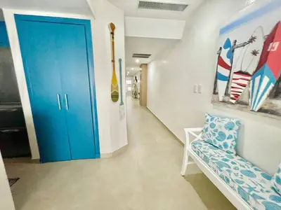 a hallway with a blue door in a room at Enjoy beach life at this gated in Juan Pedro