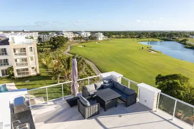 a balcony with a view of a golf course at Modern & relaxing penthouse Lake and Golf View in Punta Cana