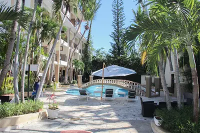 a resort with a swimming pool and palm trees at Hotel Plaza Brisas in Punta Cana