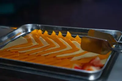 a tray of food with cheese and fruit at Hotel Plaza Brisas in Punta Cana