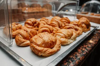 a bunch of croissants on a tray in a bakery at Hotel Plaza Brisas in Punta Cana