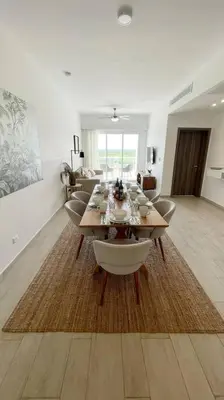 a dining room and living room with a table and chairs at Beautiful Penthouse with private elevator in Hard Rock Golf in Punta Cana
