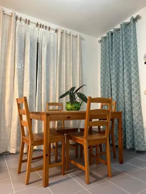 a dining room with a wooden table and chairs at EL TOUCAN, Apartament in bayahibe in Bayahibe