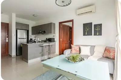 a living room with a couch and a table at Condo Apartment in Ciudad Nueva