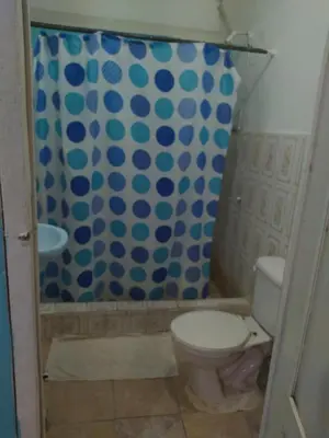 a bathroom with a toilet and a shower at Central Rooms Bayahibe in Bayahibe