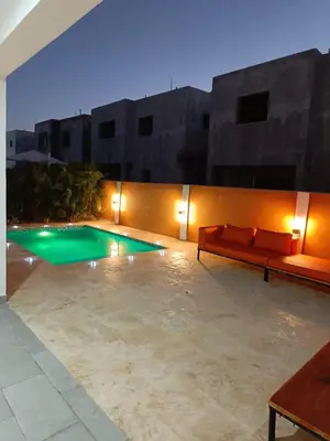 a patio with a couch and a swimming pool at Villa Selina in Punta Cana