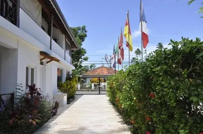 a group of flags flying outside of a building at Hotel Piedra Marron in Las Terrenas